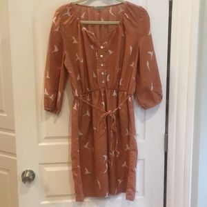 Orange dress with white bird pattern